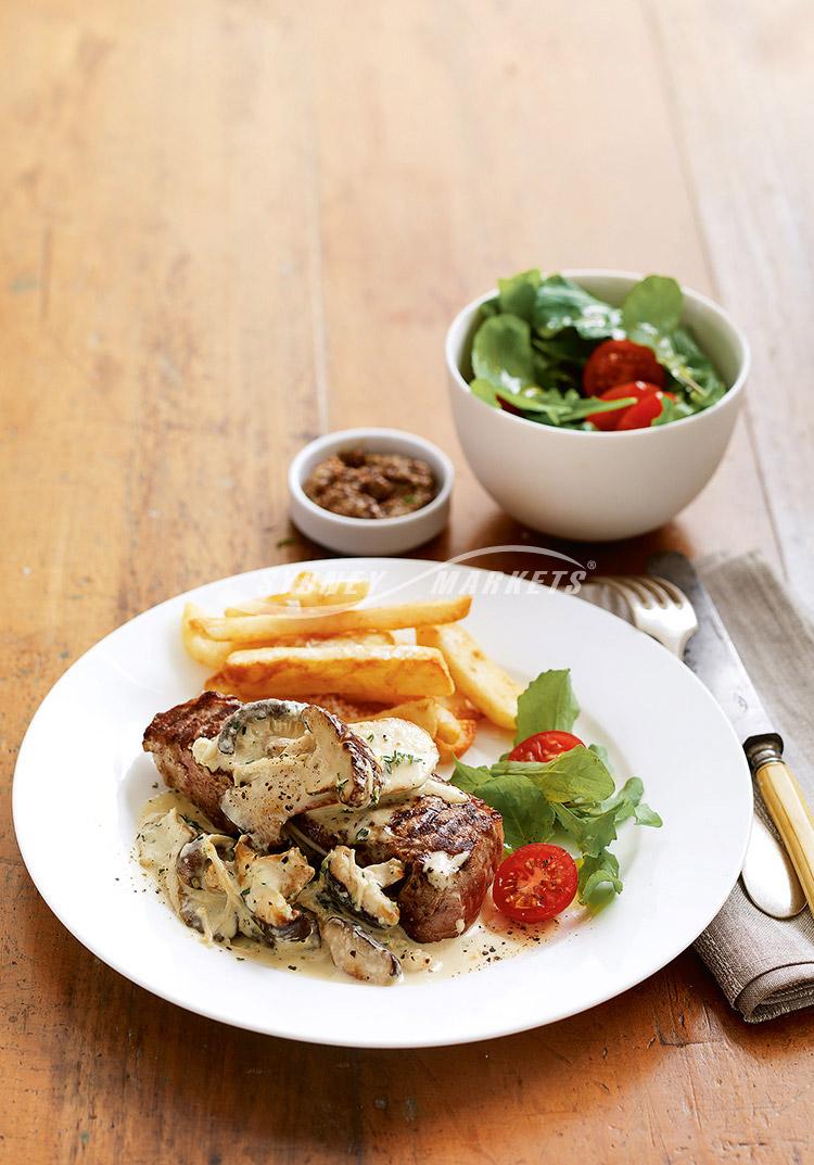 Creamy mushroom sauce with barbecue steaks